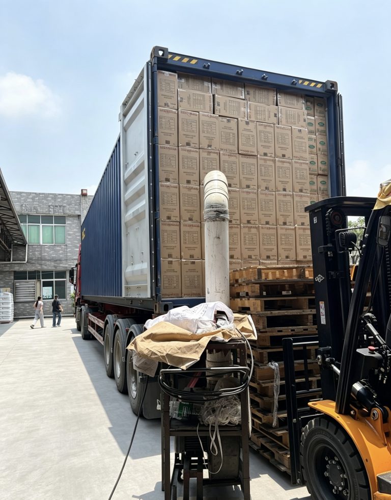 Forklift moving packed cartons into a shipping container