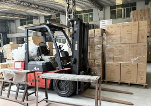 Warehouse forklift handling export cartons before loading