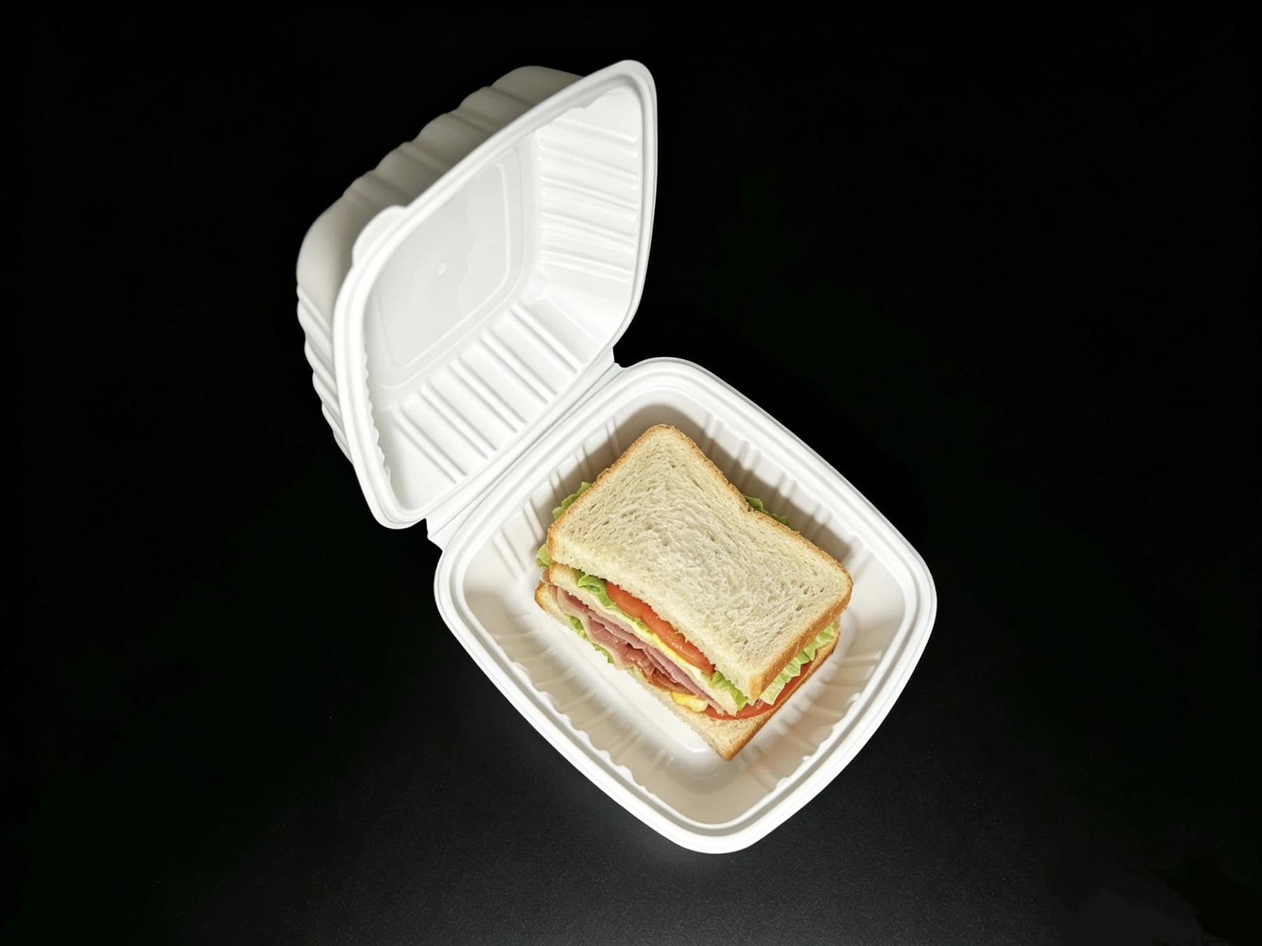 Top view of a PH60 white container holding a sandwich